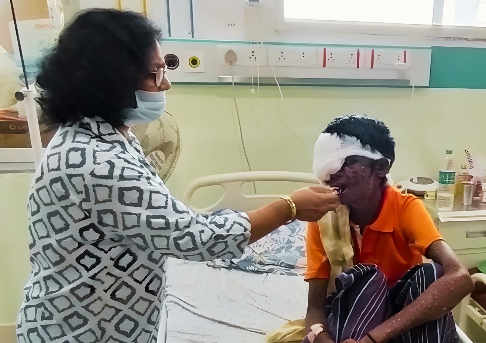 A senior person looking out a window.